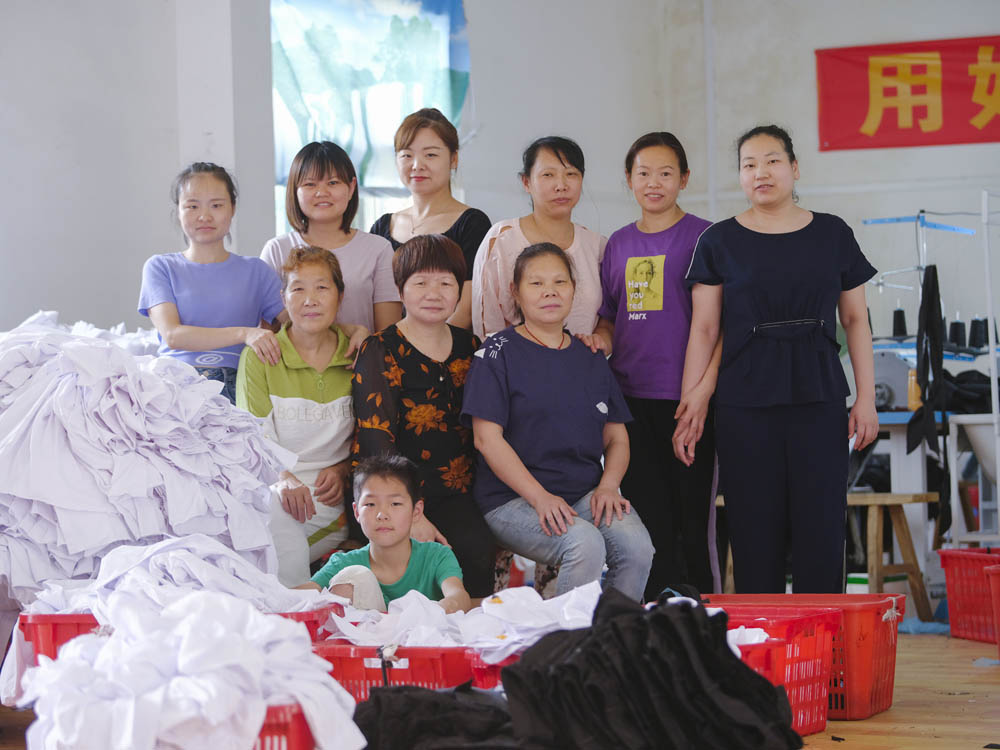 The Plus Ten factory workers consider each other sisters, and will often help colleagues pick up their children, June 2021. Courtesy of Lü Meng