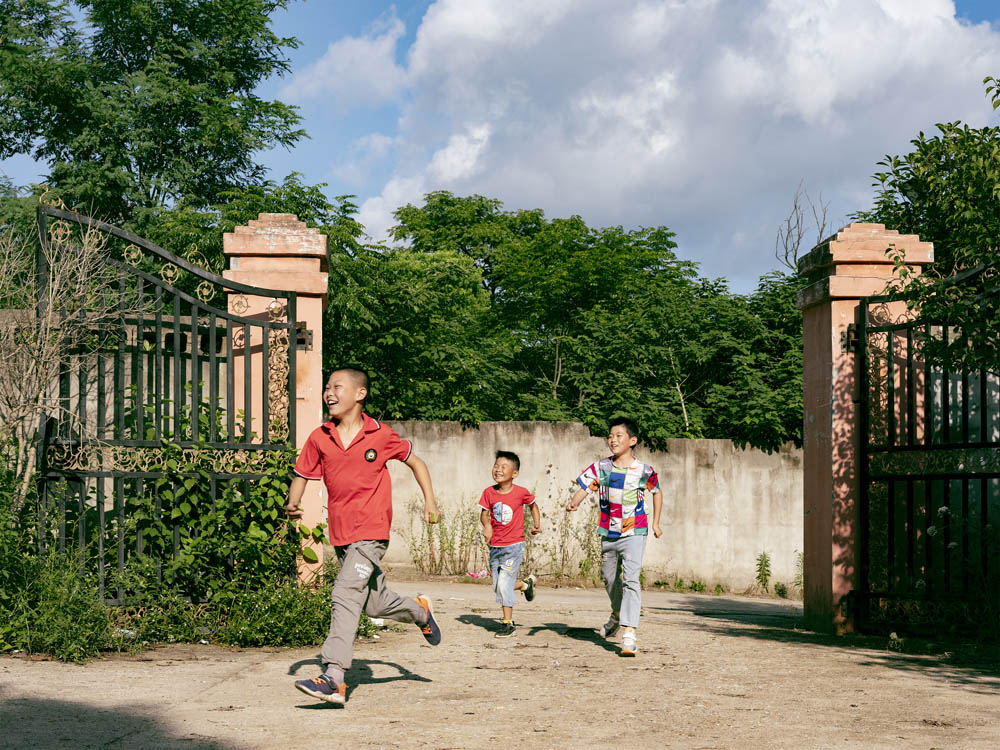 Children run and play in the courtyard of the Plus Ten factory, June 2021. Courtesy of Lü Meng