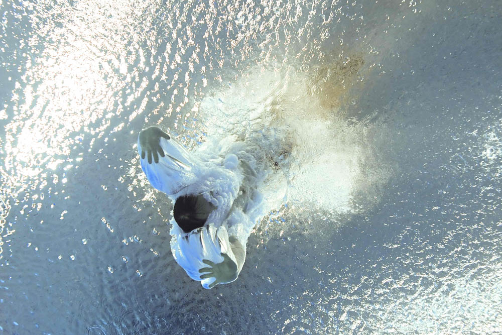 An underwater view of diver Xie Siyi as he enters the water during the men’s three-meter springboard diving event, Aug. 2, 2021. François-Xavier Marit/AFP via People Visual
