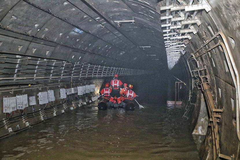 Rescue workers check the tunnel of Line 5 in Zhengzhou, Henan province, July 26, 2021. People Visual