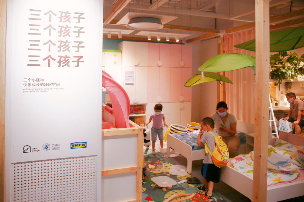Customers inspect a showroom designed for families with three children at an IKEA store in Shanghai, Aug. 12, 2021. Chen Yuyu/People Visual