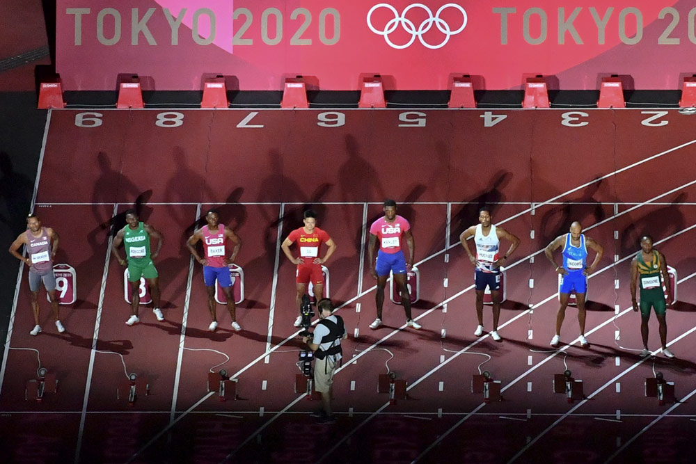 Athletes prepare for the men’s 100-meter final at the Tokyo 2020 Olympic Games in Japan, Aug. 1, 2021. Antonin Thuillier/AFP via People Visual