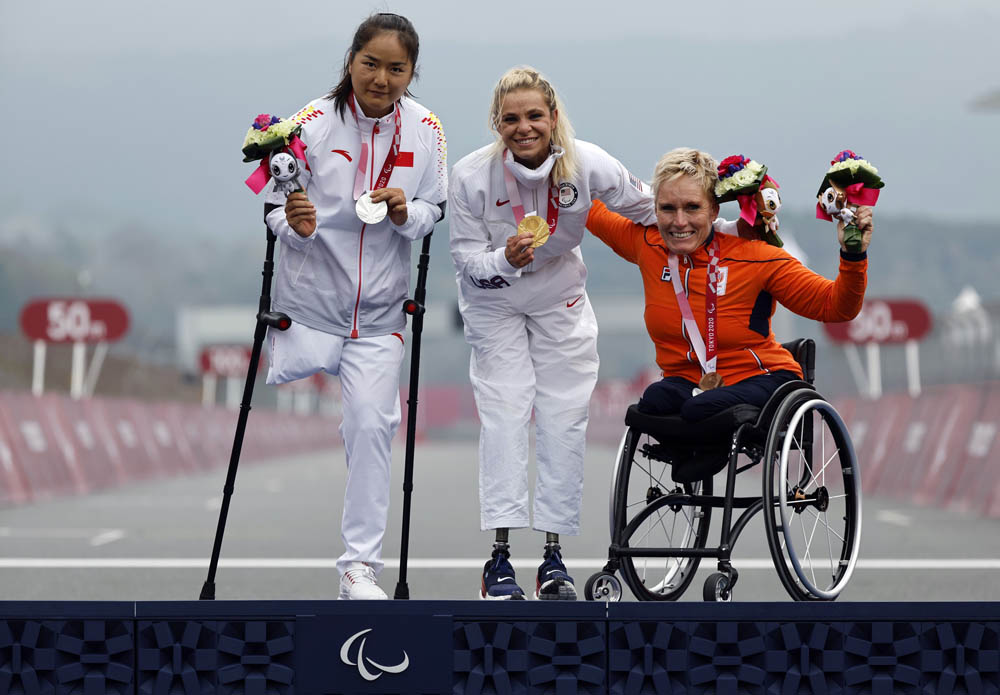 From left to right, silver medalist Sun Bianbian of China, gold medalist Oksana Masters of the United States, and bronze medalist Jennette Jansen of the Netherlands celebrate after the women’s cycling H4-5 time trial in Shizuoka, Japan, Aug. 31, 2021. Issei Kato/Reuters via IC