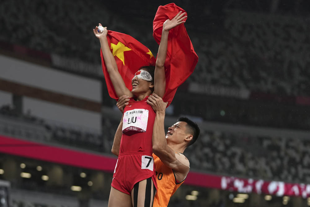 Liu Cuiqing celebrates with her guide, Xu Donglin, after winning the women’s T11 200-meter final in Tokyo, Japan, Sept. 4, 2021. Emilio Morenatti via People Visual