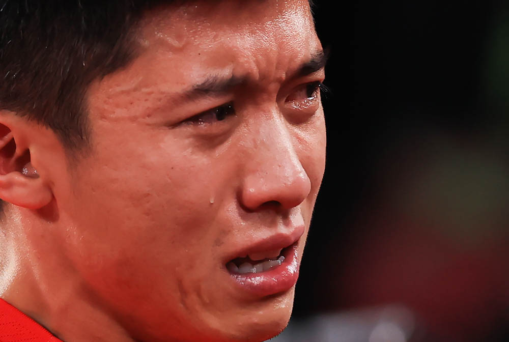 Zhai Xiang lets his emotions show after Team China’s victory over Team Germany in a ping pong match in Tokyo, Japan, Sept. 2, 2021. Carmen Mandato via People Visual