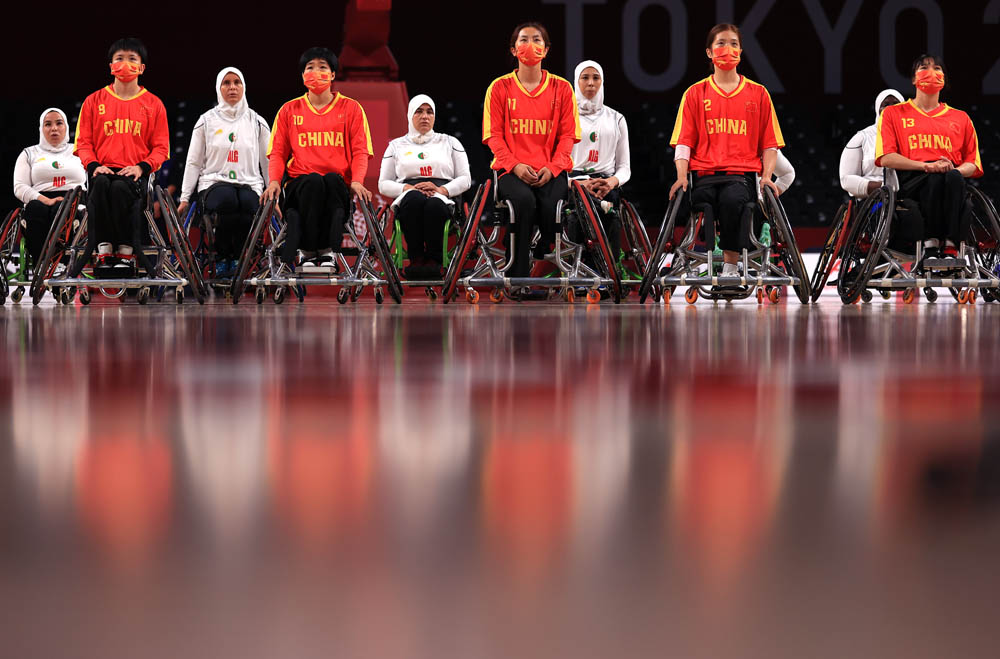 Team China and Team Algeria line up before a women’s wheelchair basketball game in Chofu, Japan, Aug. 25, 2021. Carmen Mandato via People Visual