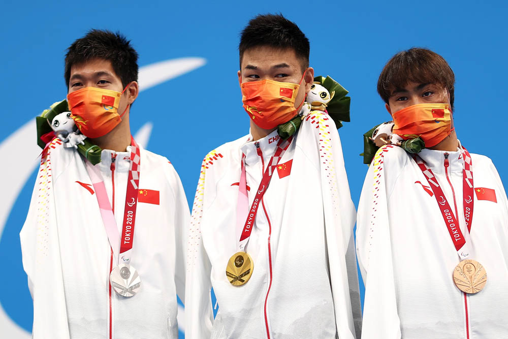 From left to right, silver medalist Wang Lichao, gold medalist Zheng Tao, and bronze medalist Yuan Weiyi pose after sweeping the men’s S5 50-meter butterfly event in Tokyo, Japan, Aug. 27, 2021. Dean Mouhtaropoulos via People Visual
