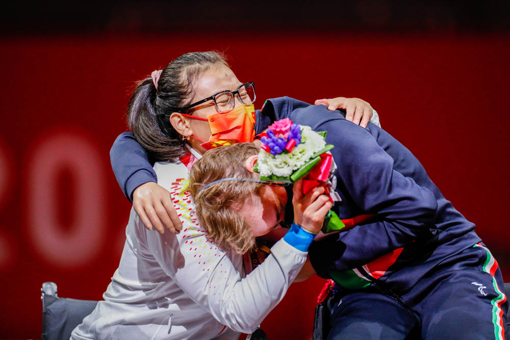 Zhou Jingjing hugs gold medalist Beatrice Vio of Italy after their fencing match in Tokyo, Japan, Aug. 28, 2021. Mauro Ujetto/NurPhoto via People Visual