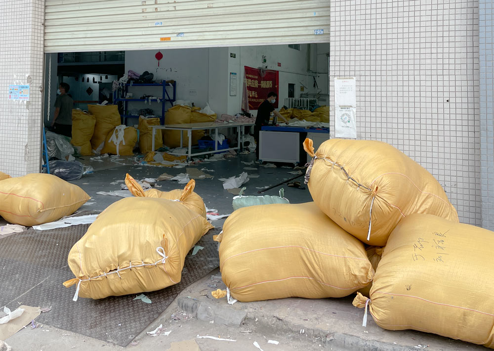Goods are stacked outside a factory that works as a direct supplier to Shein, in Guangzhou, Guangdong province, July 2021. Wu Peiyue for Sixth Tone