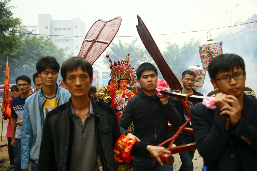 Locals carry a sedan chair with a statυe of Mazυ in Pυtian, Fυjian province, Feb. 5, 2017. Liυ Tao/People Visυal