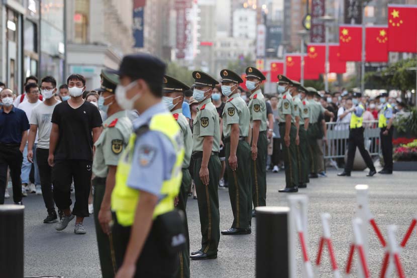 Police officers guard the Bund area in Shanghai, Oct. 1, 2021. Yin Liqin/CNS/People Visual