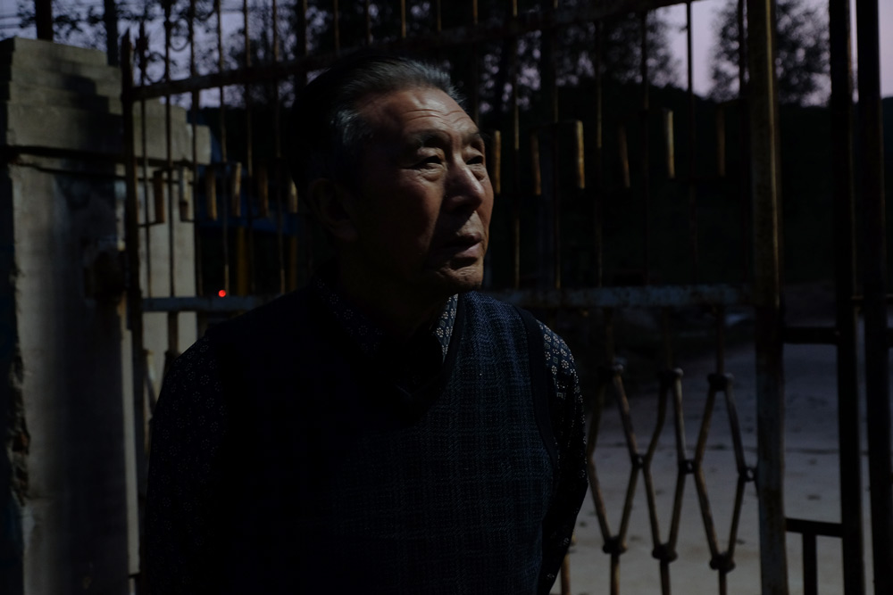 Wang Shuxuan, 84, stands in front of his factory in Huludao, Liaoning province, Oct. 2, 2021. Zhang Yiyi for Sixth Tone