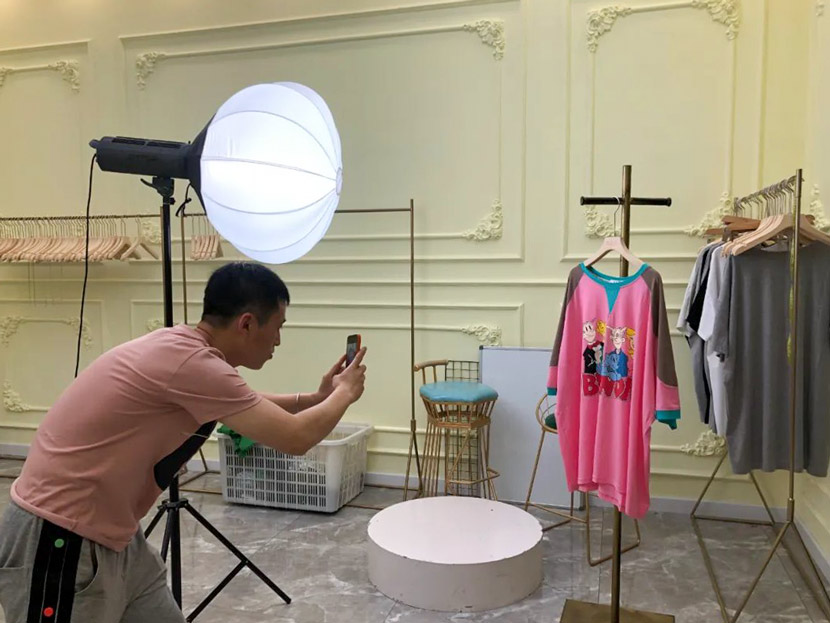 Song Pinjie takes a photo of a shirt. Courtesy of Panpan