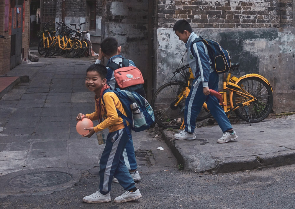 Students walk past old buildings in Guangzhou, Guangdong province, March 2019. People Visual