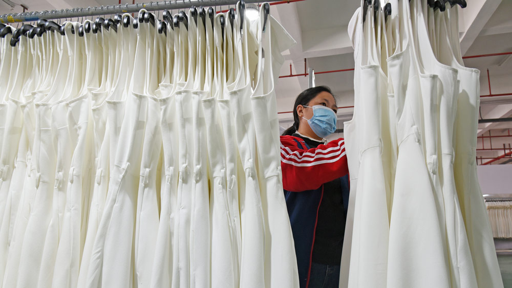 A woman checks dresses at a garment factory in Lianyungang, Jiangsu province, Nov. 4, 2021. People Visual