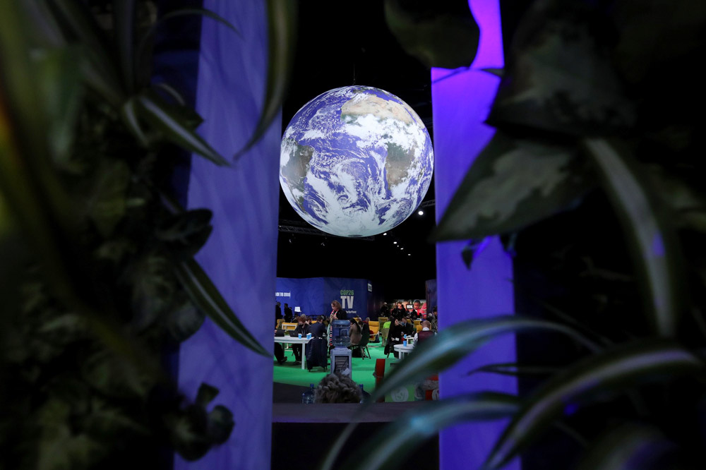 A giant model of the earth hangs in a meeting hall during COP26 in Glasgow, Scotland, Nov. 2, 2021. Yves Herman/Reuters via IC