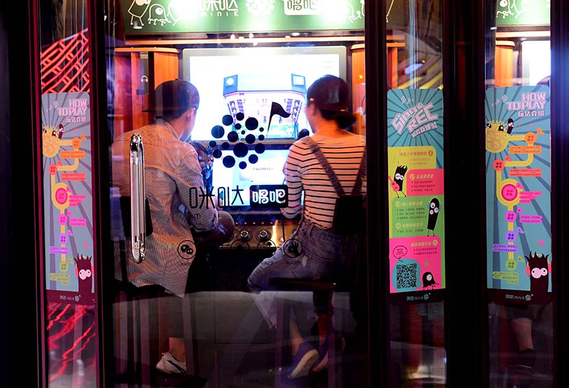 A man and a woman at a karaoke booth in Shenyang, Liaoning province, May 29, 2017. People Visual
