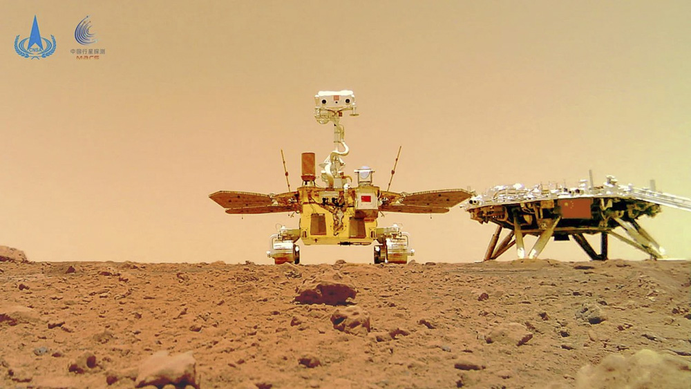 A photo of China’s Zhurong Mars rover and its landing platform, captured on the red planet by a camera detached from the rover, June 11, 2021. Xinhua