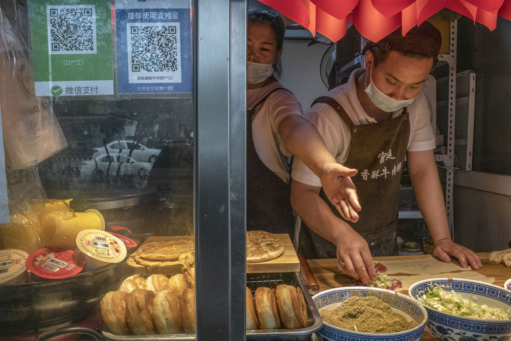 QR codes for digital payment services on display at a snack shop in Beijing, Sept. 14, 2021. Gilles Sabrie/Bloomberg via People Visual