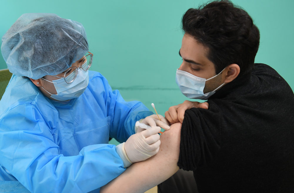 A man from Turkey receives a COVID-19 vaccine shot, in Hangzhou, Zhejiang province, April 2021. Wang Gang/CNS/People Visual