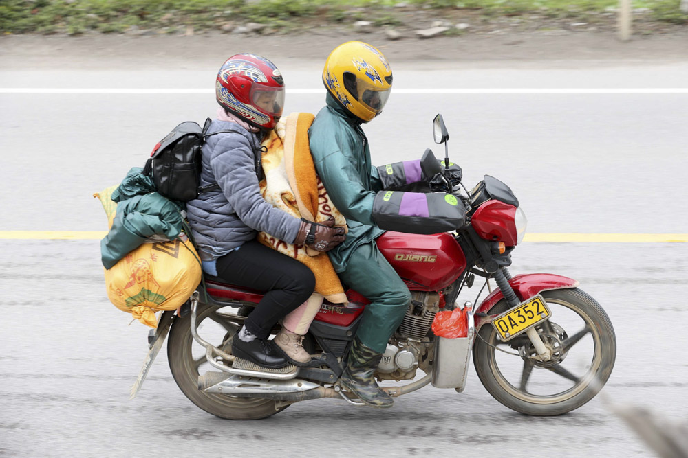Migrant workers head home on motorcycles for Chinese New Year, Rong’an County, Guangxi Zhuang Autonomous Region, Jan. 24, 2022. Tan Kaixing/IC