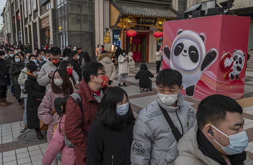 People line up to buy merchandise at the official flagship store of the Games  in Beijing, Feb. 6, 2022. Kevin Frayer/Getty Images/People Visual