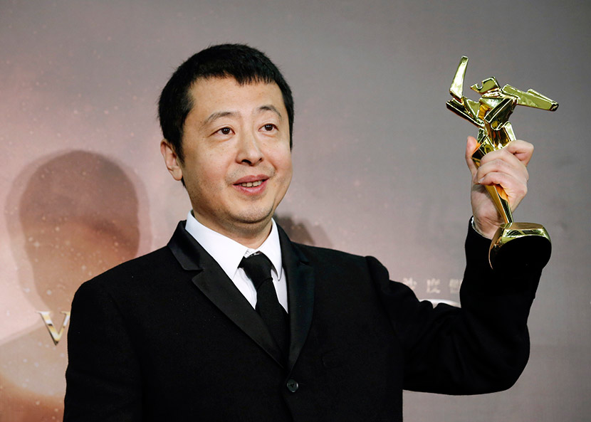 Director Jia Zhangke poses after winning the Best Screenplay award at the Asian Film Awards in Macau, March 17, 2016. IC