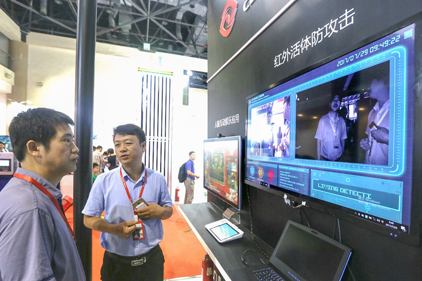 A CloudWalk staff member introduces the company’s facial recognition technology during the annual China International Financial Exhibition in Beijing, July 29, 2017. Lei Kesi/IC