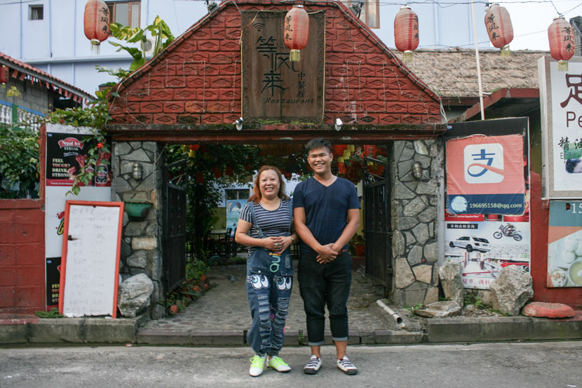 Chen Caixia (left) and her colleague, Chen Xiao, pose for a photo in front of her restaurant Up in the Wind in Pokhara, Nepal, Sept. 10, 2017. Bibek Bhandari/Sixth Tone