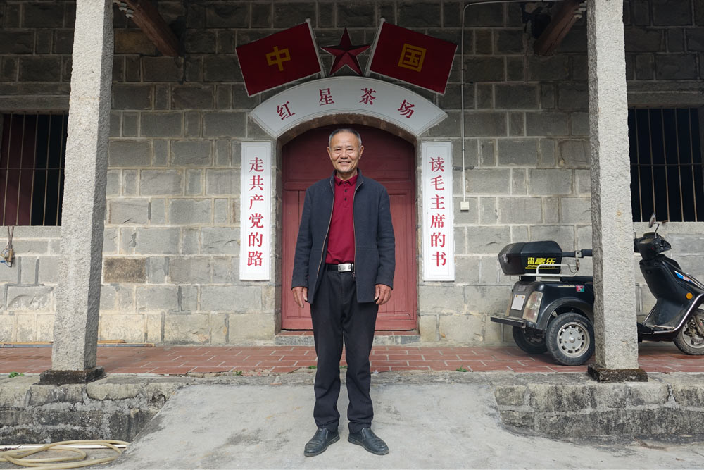 Wang Guozhen in front of one of his tea factory buildings, Dec. 30, 2021. Wu Peiyue/Sixth Tone