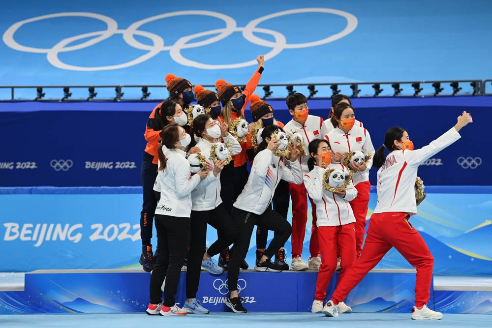 Gold medalists Team Netherlands (center), Silver Medalists Team South Korea (left) and bronze Medalists Team China (right) take a group selfie during the Women’s 3000m Relay Final A flower ceremony in Beijing, Feb. 13, 2022. Justin Setterfield/Getty Images via VCG