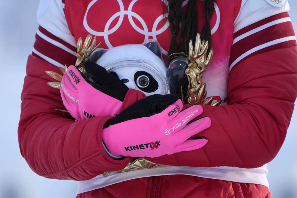 Gold medal finisher Yulia Stupak of the Russian Olympic Committee cradles a Bing Dwen Dwen award during a ceremony after the women’s 4 x 5km relay cross-country skiing competition in Zhangjiakou, Feb. 12, 2022. Aaron Favila/VCG