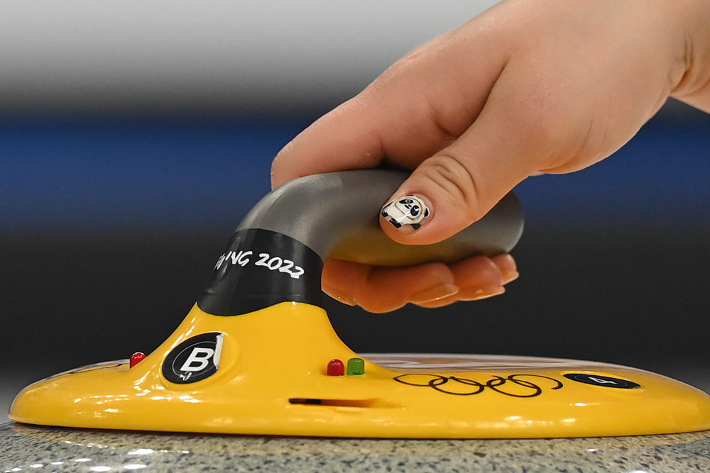 Kyeong-ae Kim of Team Korea displays Olympic mascot Bing Dwen Dwen on her nails during the Women’s Curling Round Robin Session in Beijing, Feb. 16, 2022. David Ramos/Getty Images via VCG