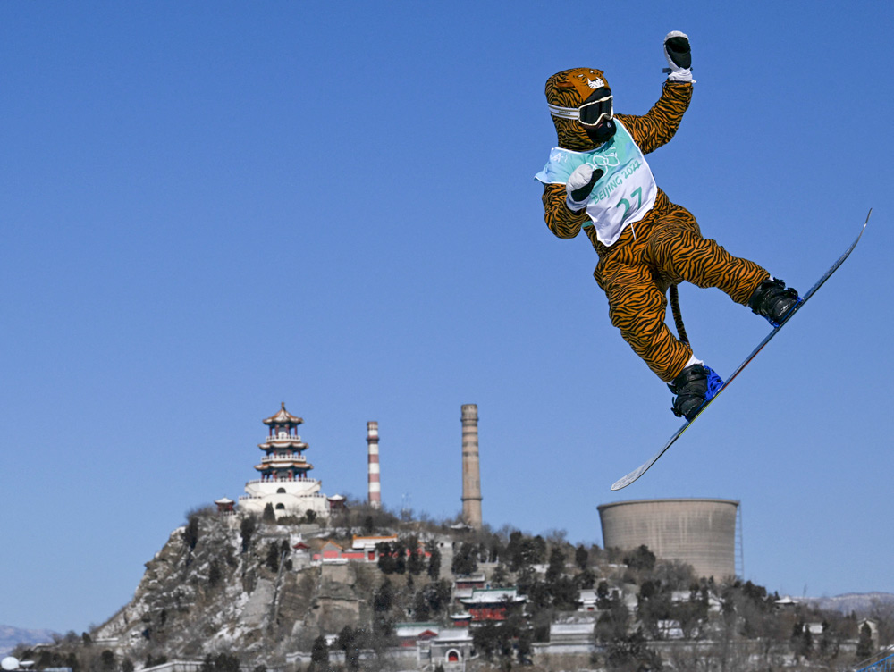 France’s Lucile Lefevre competes in tiger suit at the snowboard women’s big air qualification run in Beijing, Feb. 14, 2022. Kirill Kudryavtsev/AFP via VCG