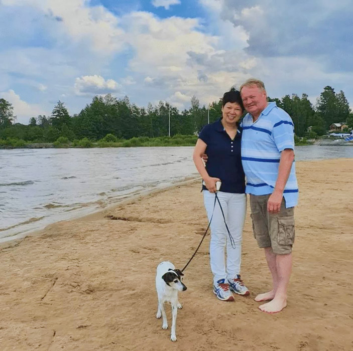 Ni Xialian poses for a photo with her husband, Tommy Danielsson, and their pet dog. Courtesy of Ni Xialian