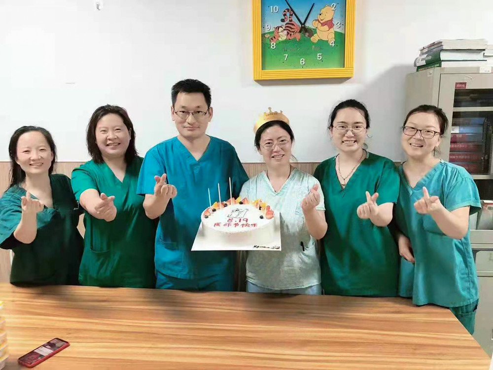 Liu Qing celebrates her birthday with her colleagues. Courtesy of Liu Qing