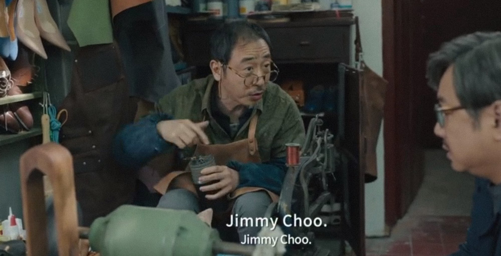 A still from 2021 film “B for Busy” shows a cobbler grinding coffee beans. From Douban
