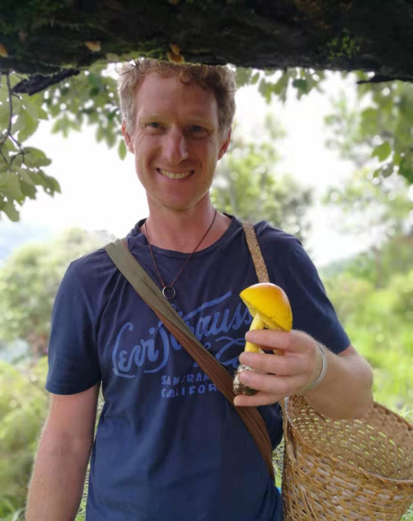 Peter Mortimer holds a new species of mushroom during a fungi-collecting expedition in the Mekong region, Yunnan province. Courtesy of Peter Mortimer
