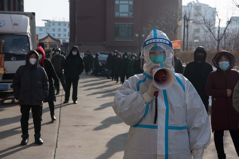 A volunteer notices residents to keep distances when receiving COVID-19 test in Shulan, Jilin province, March 31, 2022. VCG