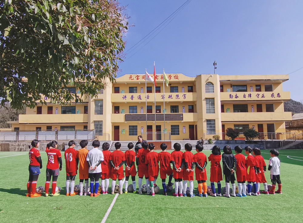 Female youth soccer players listen to Xu Zhaowei speak in Dafang County, Guizhou province, 2022. Ji Jiawen/Beijing Youth Daily
