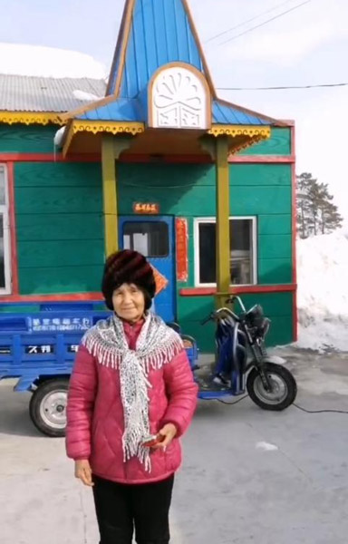 Zhang Yulan stands in front of her home. Courtesy of Zhang Yulan