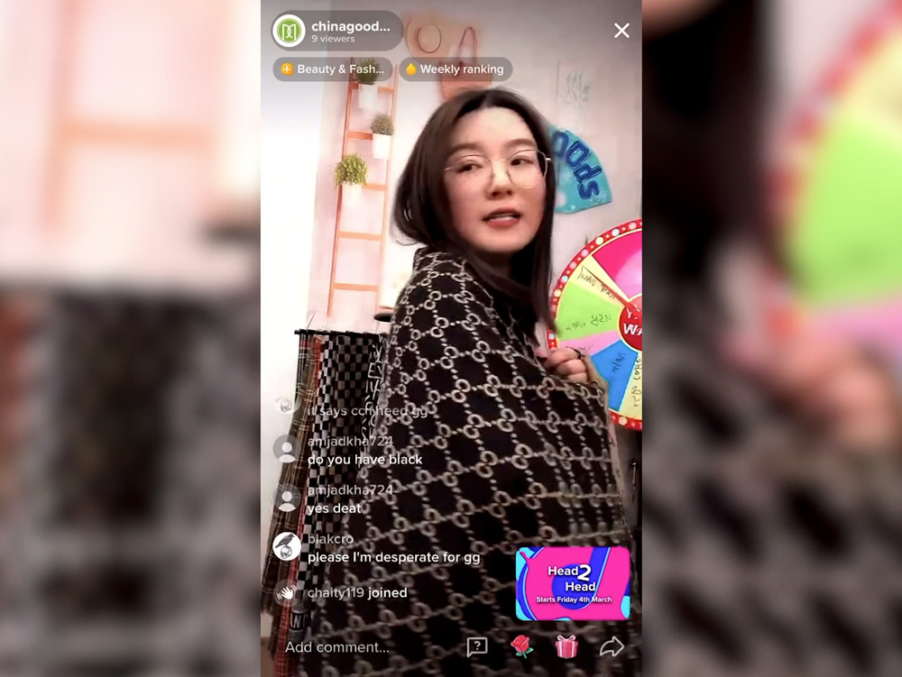 Chen Huajing models scarves during a livestream show. From TikTok