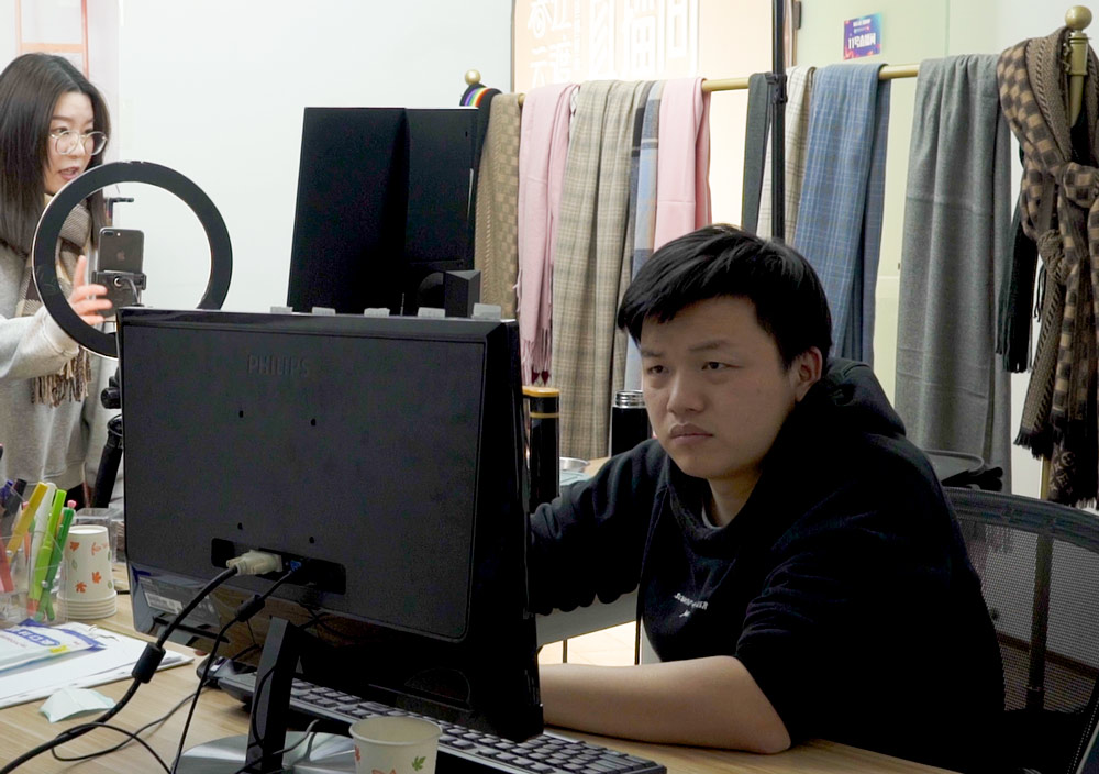 Hu Liang, director of operations at Meipin, monitors the company's livestream shows, Tonglu County, Zhejiang province, March 2022. Chen Si/Sixth Tone