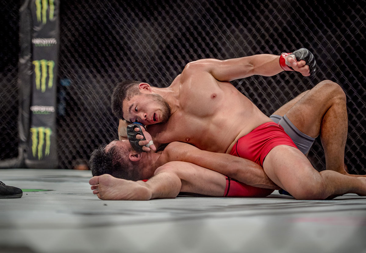 Lu Kai (in red) competes during the Road to UFC tournament in Singapore, June 2022. David Ash for Sixth Tone