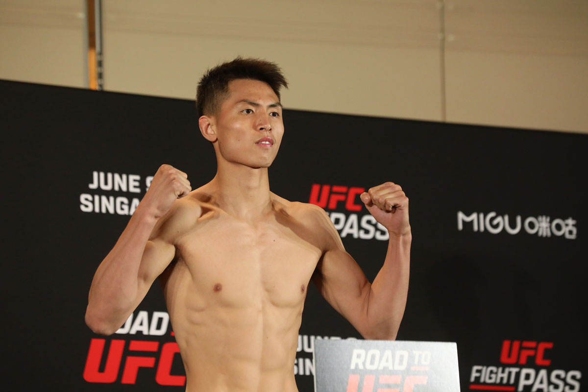 Xie Bin poses for a photo during the Road to UFC tournament in Singapore, June 2022. David Ash for Sixth Tone