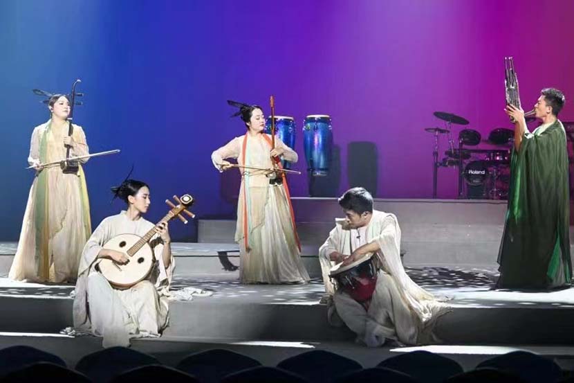 A woman wearing traditional "hanfu" outfit takes photos before the concert, Shanghai, Aug. 19, 2022. From The Paper