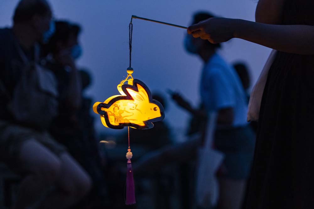 A resident carries a rabbit lantern on Lugou Bridge in Beijing, Sept. 10. 2022. Hou Yu/CNS/IC