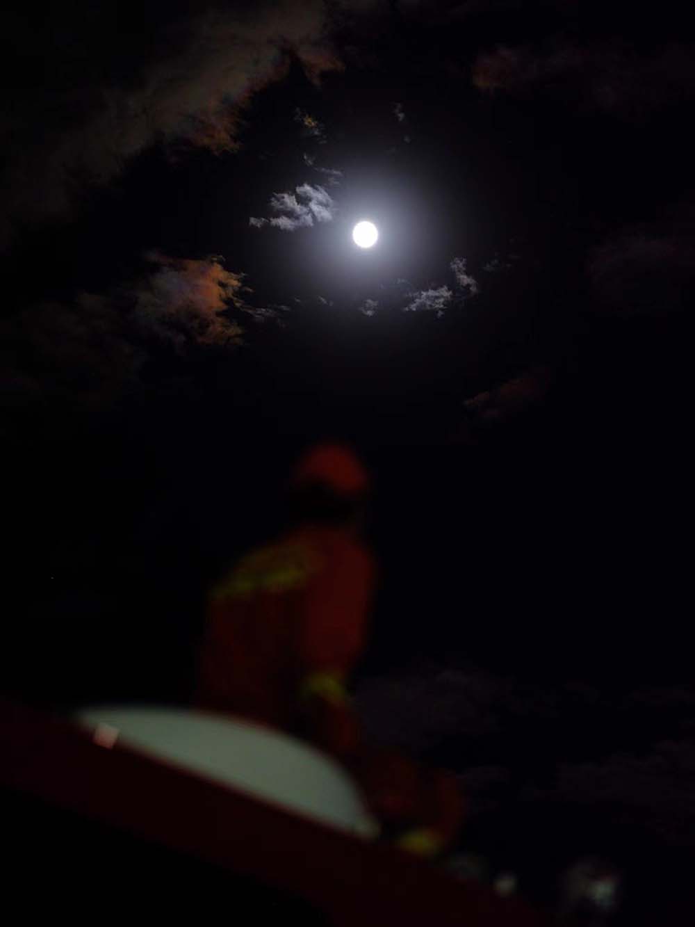 A firefighter looks at the full moon at a shelter following a 6.8-magnitude earthquake in Luding County, Ganzi Tibetan Autonomous Prefecture, Sichuan province, Sept. 10, 2022. VCG