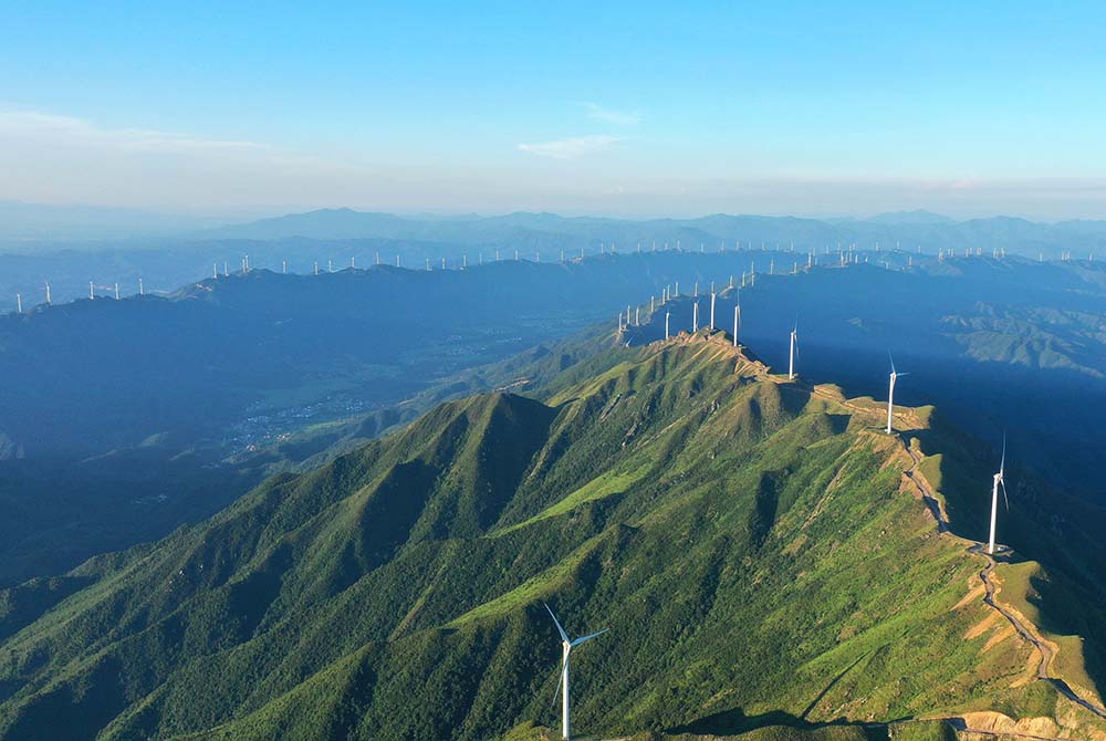 Wind power turbines line a mountain range in Ji’an, Jiangxi province, July 9, 2022. VCG