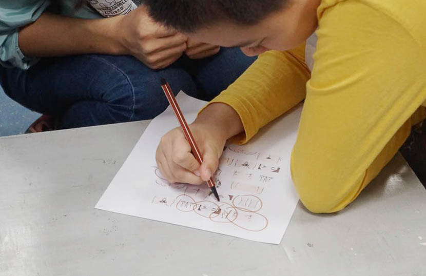 A boy with autism circles private parts on a worksheet during a sex education class at No. 2 Children’s Palace, Guangzhou, Guangdong province, Nov. 5, 2017. Fan Yiying/Sixth Tone